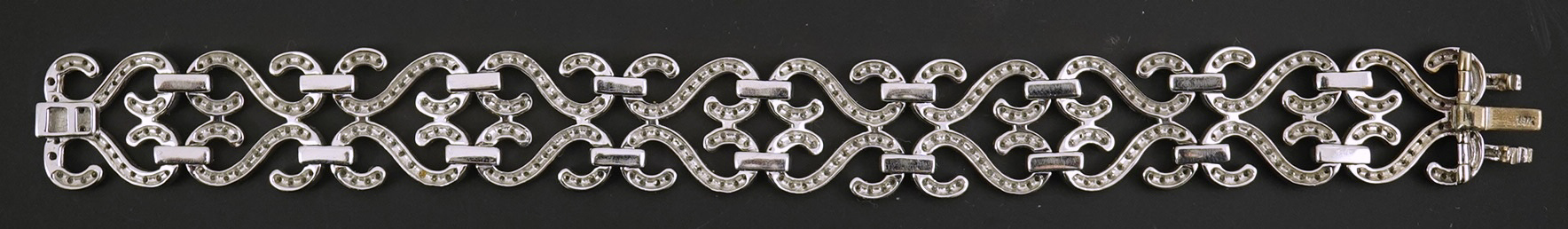 A modern 18k white gold and diamond chip cluster set bracelet